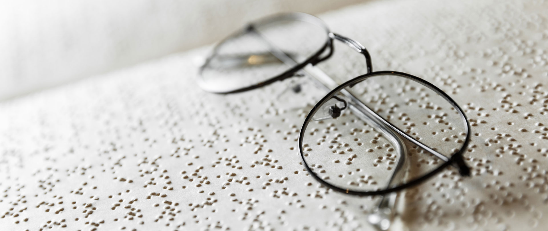 braille text on old book and glasses