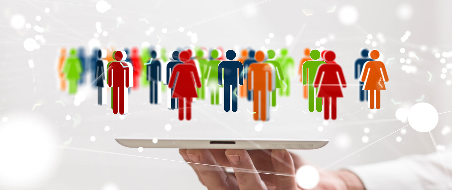 A hand holding tablet device with colourful people figures floating above, representing inclusion and diversity.